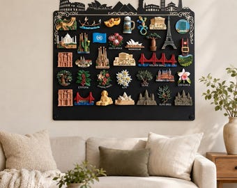 May include: A rectangular black magnetic display board featuring a decorative skyline silhouette at the top. The board is covered with numerous colorful three-dimensional souvenir magnets depicting various global landmarks, plants, and cultural icons.
