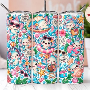 May include: Three cylindrical tumblers with metal straws featuring a colourful pattern of cartoon axolotls, tropical flowers, seashells, and bubbles. The designs include text bubbles with phrases like Good Vibes, Just Chill, Stay Cool, and No Worries.