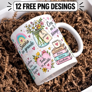 May include: A white ceramic mug featuring colorful illustrations of a flower-filled mason jar, a rainbow, a pink heart, and a stack of books. The mug includes Spanish text such as Sueña en grande, Todo es posible, and Cree en ti siempre.