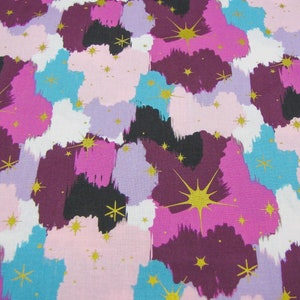 May include: A colorful fabric with a repeating pattern of brushstrokes in shades of pink, purple, blue, and black. Gold glitter stars are scattered throughout the design.