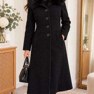 May include: A long black coat featuring a plush faux fur collar, a button-down front closure, and two side pockets. The coat is paired with a small black handbag and black boots, creating a structured silhouette that extends to the mid-calf.