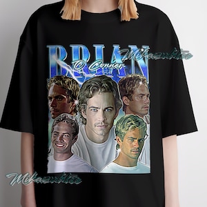 May include: Black t-shirt featuring a collage of images of a person, with the name "Brian O'Conner" in blue text. The design includes multiple portraits of the person in various poses, with a vintage aesthetic.