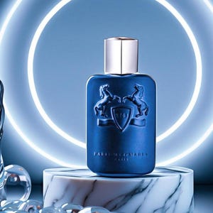May include: A blue perfume bottle with a silver cap, featuring a crest with two horses. The bottle is on a marble stand, with a glowing blue neon light in the background. The brand name is visible on the bottle.