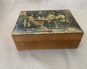 May include: A wooden box with a hinged lid. The lid is decorated with a vintage illustration of five men sitting around a table playing cards. The box is brown and has a distressed look.