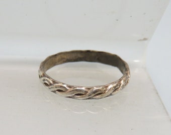 May include: A silver ring with a braided design.