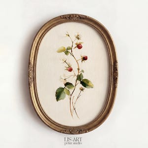 May include: An oval, gold-framed print featuring a watercolor illustration of a raspberry branch with red berries, white flowers, and green leaves. The frame has ornate detailing. The print is on a cream-colored background. The text "LIS ART print studio" is at the bottom.