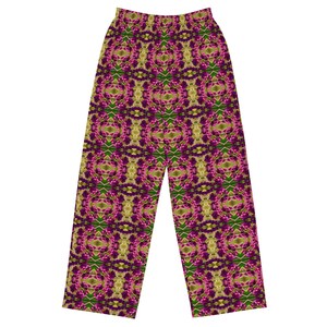 May include: A pair of pajama pants with a repeating floral pattern in shades of purple, green, and gold. The pants have a wide-leg design and an elastic waistband. The overall aesthetic is bohemian and artistic.