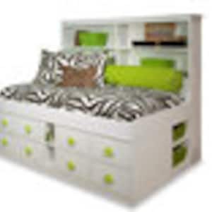 May include: White storage bed with a headboard featuring shelves and a built-in bookcase. The bed has a zebra-print comforter and decorative pillows in shades of green and brown. The bed frame includes multiple drawers and storage compartments.