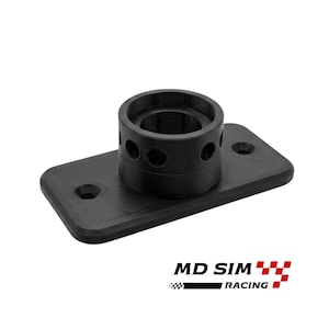 May include: A black, 3D-printed component with a cylindrical top section featuring multiple circular holes. The component is mounted on a rectangular base with two circular mounting holes. The text "MD SIM RACING" is printed at the bottom.