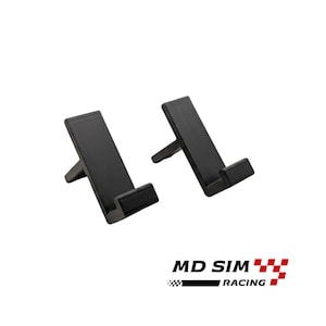 May include: Two black phone stands with a minimalist design. Each stand has a rectangular base and a support leg, angled for optimal viewing. The stands are made of a matte black material. The logo "MD SIM RACING" is at the bottom.