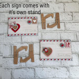 May include: A rustic wooden sign with the word "Welcome" in a handwritten style. The sign has a distressed finish and a simple, inviting design, suitable for a front porch or entryway.