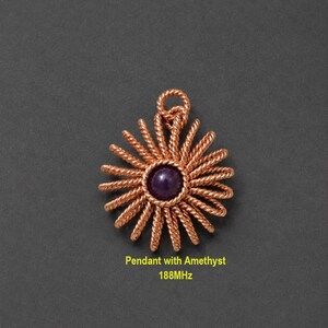 May include: A copper wire pendant featuring a circular sunburst design with twisted wire rays radiating from a central, smooth, round, deep purple amethyst gemstone. The text "Pendant with Amethyst 188MHz" is printed below the jewelry piece.