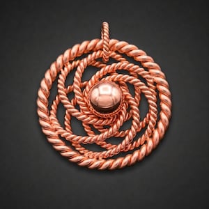 May include: A circular copper pendant featuring a central polished sphere surrounded by multiple concentric layers of twisted rope-style wire. The design includes a small vertical loop at the top for attachment, showcasing a metallic finish.