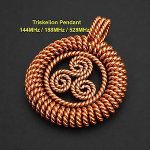 May include: A copper-coloured Triskelion pendant featuring a circular frame made of twisted wire with a central three-spiral design. The text "Triskelion Pendant 144MHz / 188MHz / 528MHz" is printed in yellow above the pendant against a dark background.