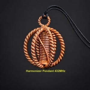 May include: A copper-colored pendant featuring a central coiled cylinder surrounded by three intersecting twisted rope-like rings, suspended from a black cord. The text "Harmonizer Pendant 432MHz" is printed in yellow at the bottom of the image.