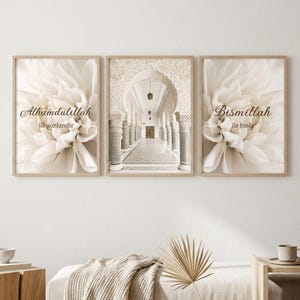 May include: A set of three framed wall art pieces. The left and right frames feature a close-up of a white flower with the text "Alhamdulillah ile sonlandir" and "Bismillah ile basla". The center frame displays a long hallway with columns.