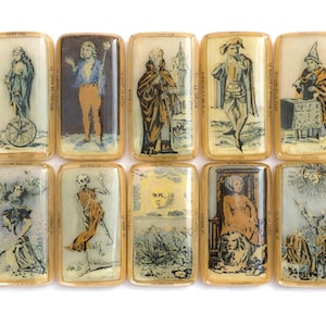 May include: A collection of ten rectangular, antique tarot cards. Each card features a unique illustration with figures and symbols, framed in gold. The cards depict various scenes, including a figure on a wheel, a skeleton, and a person with a lion.