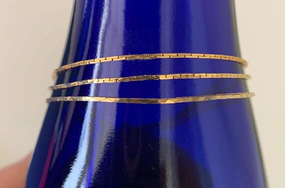 Three Thin Stack able Korea Signed Gold Tone Flat… - image 1