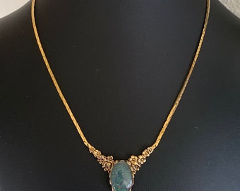 Elegant Bright Gold Tone Chain V Neck Choker Necklace With A Flower and Glittery Blue Cabochon Decorative Focus