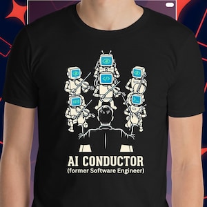 May include: Black t-shirt featuring a graphic of an orchestra conducted by a person with a back view. The orchestra consists of robots with screens for heads playing violins. Text reads "AI CONDUCTOR (former Software Engineer)".