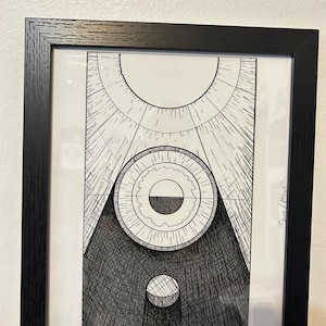 May include: Black framed art print featuring a geometric design in black and white. The artwork includes circular and triangular shapes with radiating lines, creating a sun-like effect. The print is labeled "15in / 15in".