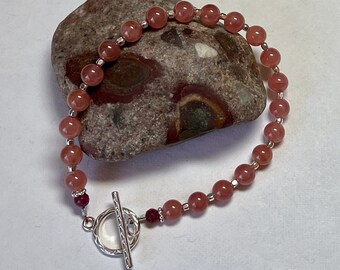 AAA-grade rhodochrosite, ruby & sterling silver bracelet: charity donation