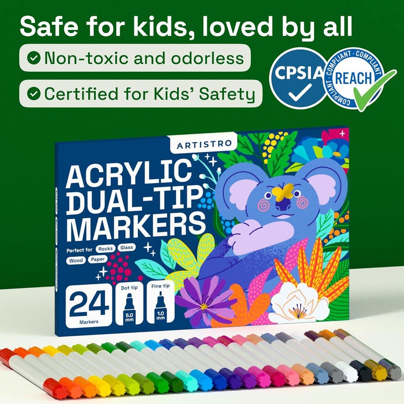 May include: A box of Artistro acrylic dual-tip markers with a koala illustration. The box is navy blue with white text and a colorful koala design. Twenty-four markers are displayed below the box, each with a different color tip.