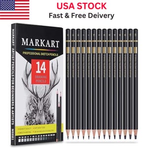 May include: A black box of Markart professional sketch pencils with a deer illustration and the number 14. The box is next to a row of black pencils with gold accents. The text "USA STOCK" and "Fast & Free Delivery" is visible.