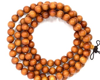 May include: A strand of wooden beads in a warm brown hue. The beads are round and appear to be made of a natural wood material. The necklace is displayed on a white background. The beads are approximately 0.8 cm in diameter.