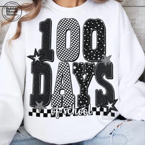 May include: White sweatshirt with a graphic design celebrating 100 days of school. The design features the numbers "100" with a checkered pattern, stars, and leopard print accents. The words "DAYS of school" are also included.