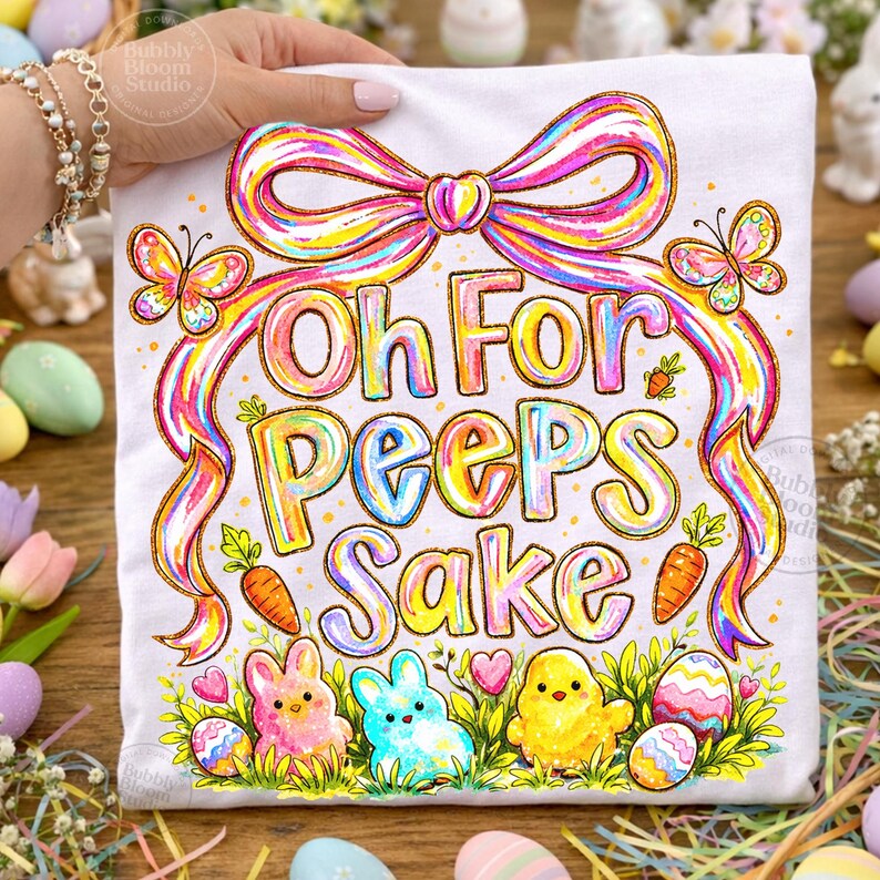 May include: White t-shirt with a colorful Easter design. The shirt features the phrase "Oh For Peeps Sake" in rainbow lettering, along with illustrations of bunnies, a chick, carrots, butterflies, and Easter eggs. A large rainbow bow tops the design.
