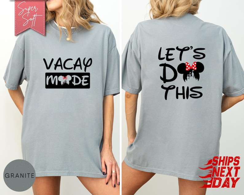 May include: A light gray t-shirt with the words "VACAY MODE" printed on the front and "LET'S DO THIS" on the back. The front design includes a black rectangle with a Mickey Mouse head silhouette. The back design features a Mickey Mouse head with a red bow.