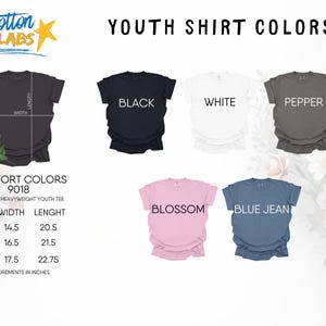 May include: A colour chart for Comfort Colors 9018 unisex heavyweight youth t-shirts, displaying five shirts in black, white, pepper, blossom, and blue jean. A size chart lists width and length measurements in inches for sizes S, M, and L.