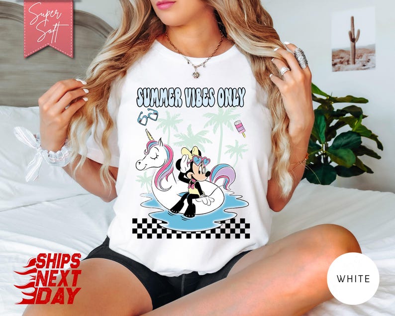 May include: A white t-shirt featuring the text SUMMER VIBES ONLY in a wavy font. The graphic shows a cartoon mouse wearing heart-shaped sunglasses sitting on a unicorn pool float in blue water, surrounded by palm trees, sunglasses, and a popsicle.