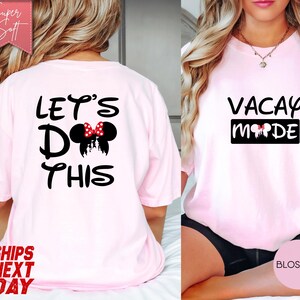 May include: Light pink t-shirts with black text and Minnie Mouse-themed graphics. One shirt says "Let's Do This" with a Minnie Mouse bow and silhouette. The other says "Vacay Mode" with a Minnie Mouse graphic.