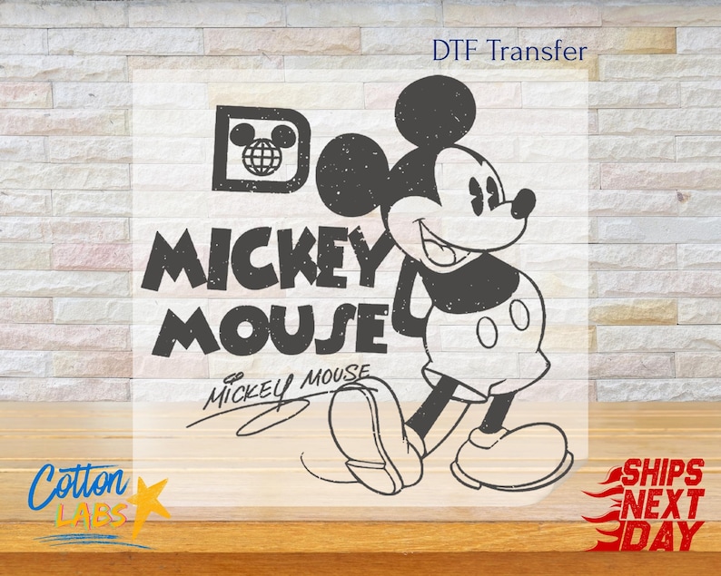 May include: Black and white graphic of Mickey Mouse with the text "Mickey Mouse" and a signature. The design includes a vintage-style logo with a globe and Mickey Mouse ears.