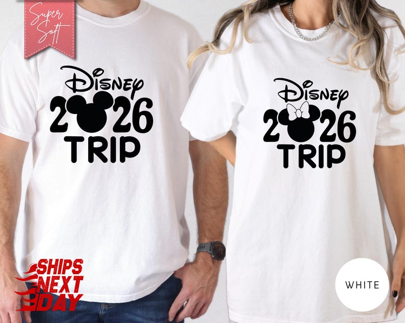 May include: White t-shirts with a black Disney design. The design includes the word "Disney", the numbers "2026", a Mickey Mouse head, and the word "TRIP". One shirt has a bow on the Mickey Mouse head. The shirts are labeled "Super Soft".