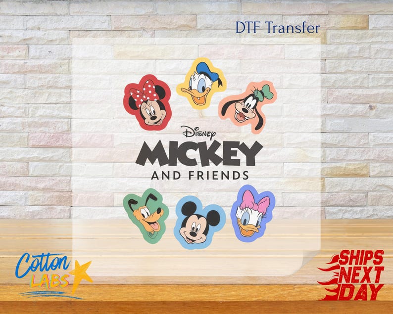 May include: DTF transfer featuring Disney's Mickey and Friends. The design includes images of Mickey Mouse, Minnie Mouse, Donald Duck, Daisy Duck, Goofy, and Pluto. The text "Mickey and Friends" is also included.