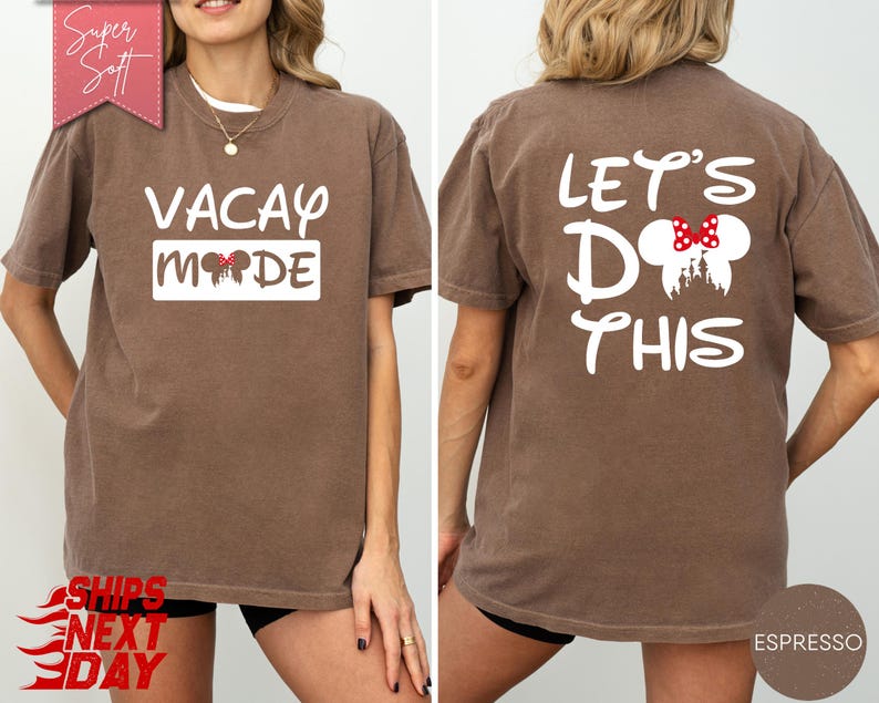 May include: Espresso-colored t-shirt with "VACAY MODE" printed on the front and "LET'S DO THIS" on the back. The front design includes Mickey Mouse ears, and the back features a Mickey Mouse head with a red bow. The shirt is a soft, casual style.