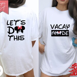 May include: White t-shirts with black text and Minnie Mouse-themed graphics. One shirt says "LET'S DO THIS" with a Minnie Mouse bow and silhouette. The other says "VACAY MODE" with a similar design. The shirts are labeled "Super Soft" and "White".