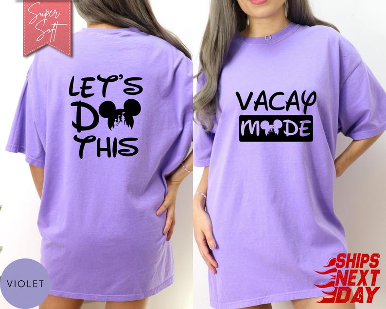 May include: A violet-colored t-shirt with the text "LET'S DO THIS" and a Mickey Mouse silhouette on the back. The front of the shirt features the words "VACAY MODE" with a Mickey Mouse silhouette. The shirt is a casual, oversized fit.
