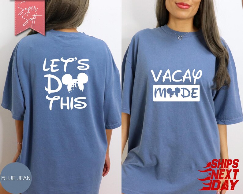 May include: Blue jean-colored t-shirt with white text and graphics. The front of the shirt says "VACAY MODE" with a Mickey Mouse head silhouette. The back says "LET'S DO THIS" with a Mickey Mouse head and castle graphic.