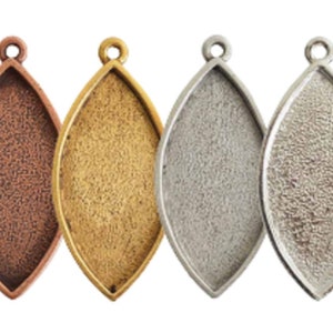 May include: Four pendant trays in different metal finishes: copper, gold, silver, and antique silver. Each tray is shaped like a teardrop and has a textured surface.