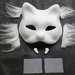 May include: A white cat-shaped mask with pointed ears and black eye cutouts, accompanied by four separate pieces of white faux fur, two small white fangs, and two rectangular pieces of white plastic mesh grid for crafting and assembly.