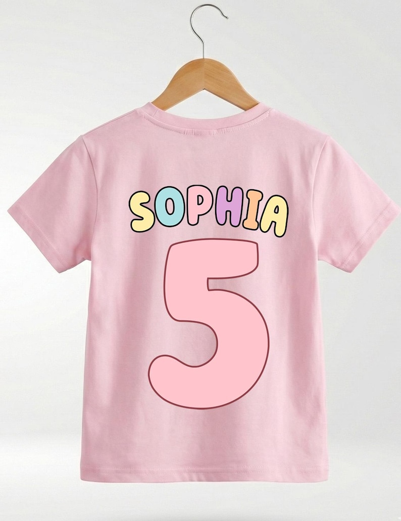 A pink t-shirt with the name "Sophia" and the number "5" printed on it.