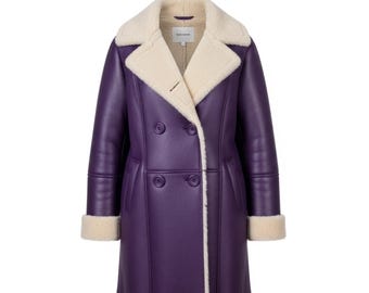 May include: A double-breasted purple coat with a cream-colored shearling collar, cuffs, and interior lining. The coat features two rows of buttons and a tailored fit. The brand name is visible on the collar.