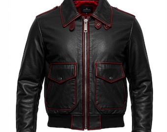 May include: Black leather bomber jacket with red trim and lining. Features a zip-up front, two front pockets, and a ribbed knit hem and cuffs. The jacket has a classic collar and a tailored fit, suitable for outerwear.
