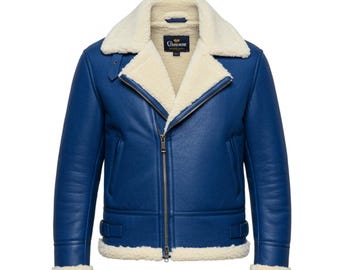 May include: A blue leather jacket with a cream-colored shearling lining and collar. The jacket features a zipper closure, side pockets, and a buckled belt detail at the waist. The jacket has a classic aviator style.