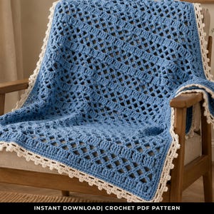 May include: A blue crochet blanket with a diamond pattern and a cream-colored scalloped border is draped over a wooden chair. The blanket is made of soft yarn and has a textured appearance. The image includes the text "INSTANT DOWNLOAD| CROCHET PDF PATTERN".