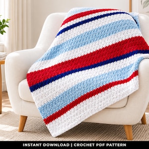 May include: A crochet blanket featuring a repeating striped pattern in vibrant red, deep navy blue, light sky blue, and crisp white. The textured yarn creates a soft, cozy appearance with distinct horizontal bands of color throughout the design.